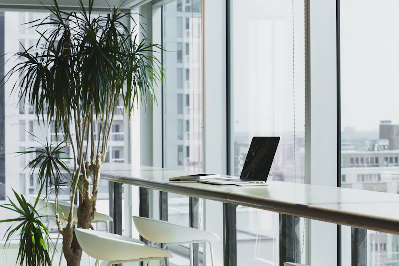 A bright, modern office with a laptop on a desk by the window
