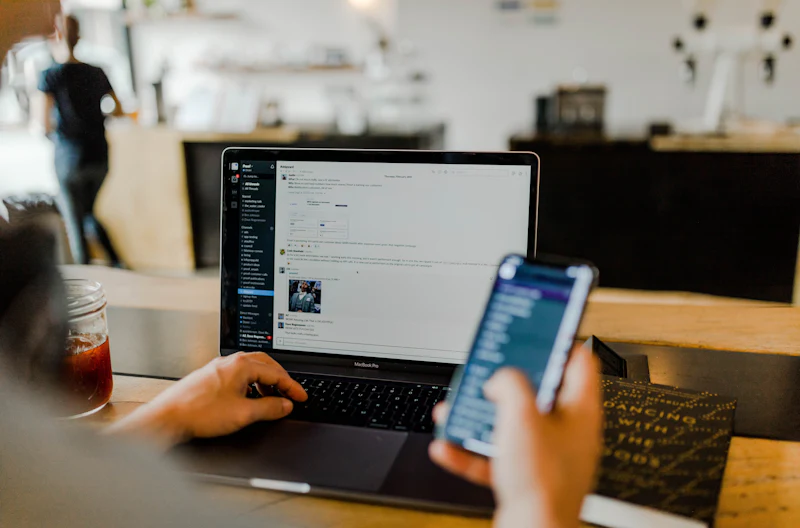 A phone, tablet and laptop side by side on a desk
