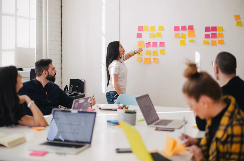 A team planning work with sticky notes on a wall